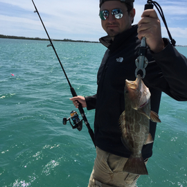Holding up his catch